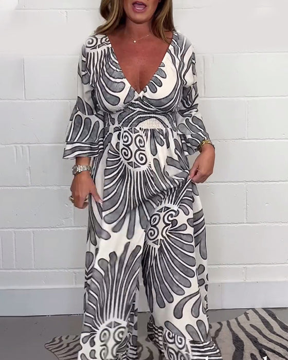 Lös jumpsuit med djup V retrotryckt klockärm